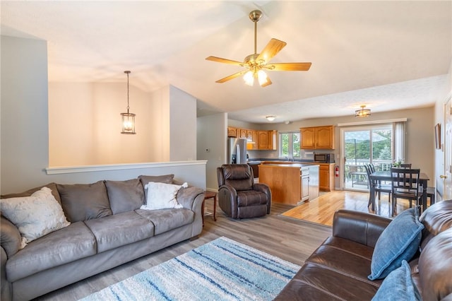11 Wenrich Cir, Henrietta, NY 14586 - living area featuring light wood-style floors, vaulted ceiling, and a ceiling fan