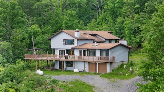 4570 Vine Rd, Jerusalem, NY 14527 - back of house featuring a view of trees, a chimney, and driveway