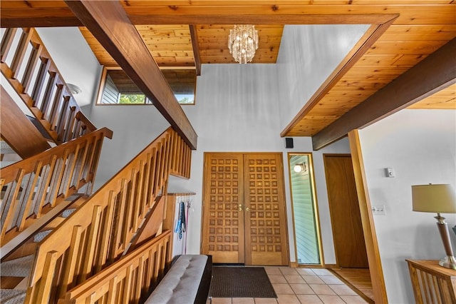 4570 Vine Rd, Jerusalem, NY 14527 - entryway with stairs, light tile patterned floors, a towering ceiling, a wood ceiling with exposed beams, and a chandelier