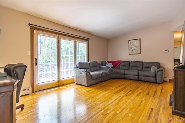 4947 Seneca St, West Seneca, NY 14224 - living room with light wood finished floors, a baseboard radiator, and lofted ceiling