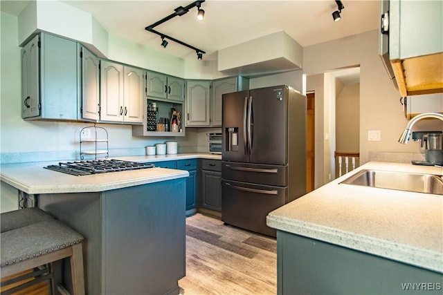 4947 Seneca St, West Seneca, NY 14224 - kitchen featuring appliances with stainless steel finishes, track lighting, a peninsula, light wood finished floors, and light countertops