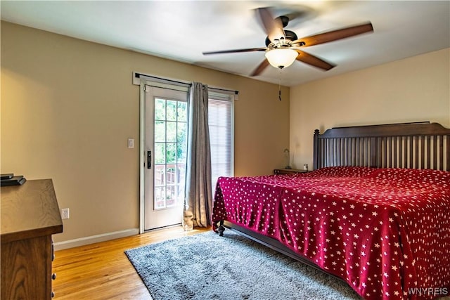4947 Seneca St, West Seneca, NY 14224 - bedroom with wood finished floors, access to exterior, and a ceiling fan