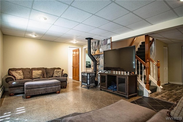 4947 Seneca St, West Seneca, NY 14224 - living area featuring a wood stove, a paneled ceiling, and stairway