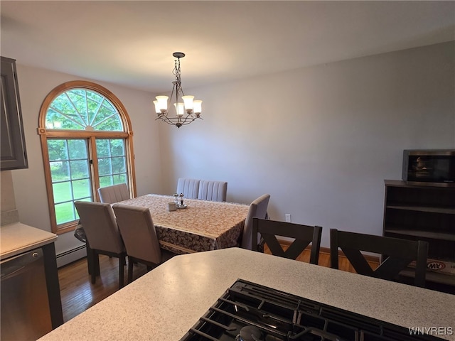 4947 Seneca St, West Seneca, NY 14224 - dining space with a chandelier, dark wood-style floors, and a baseboard heating unit