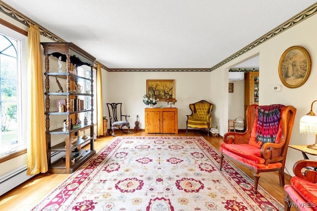1581 N Forest Rd, Amherst, NY 14221 - sitting room with an AC wall unit, healthy amount of natural light, and light wood-type flooring