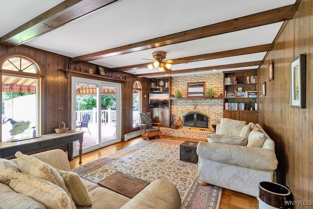 1581 N Forest Rd, Amherst, NY 14221 - living room with wooden walls, wood finished floors, a baseboard heating unit, ceiling fan, and beamed ceiling