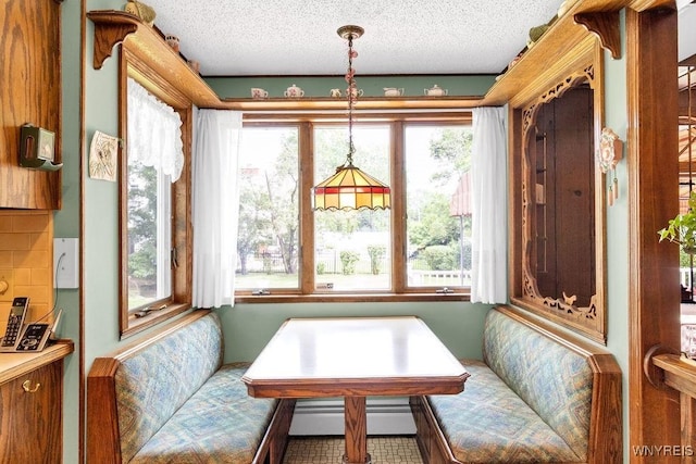 1581 N Forest Rd, Amherst, NY 14221 - dining area featuring a baseboard radiator and a textured ceiling