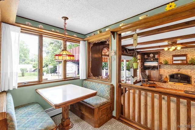 1581 N Forest Rd, Amherst, NY 14221 - dining area with healthy amount of natural light, a textured ceiling, and beam ceiling