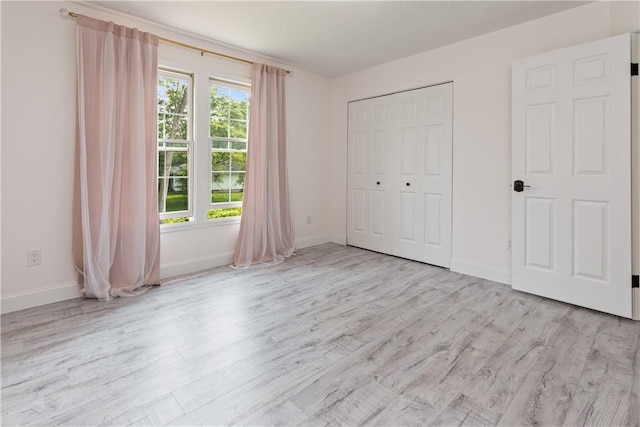 151 Crab Apple Ln, Greece, NY 14626 - unfurnished bedroom featuring wood finished floors and a closet