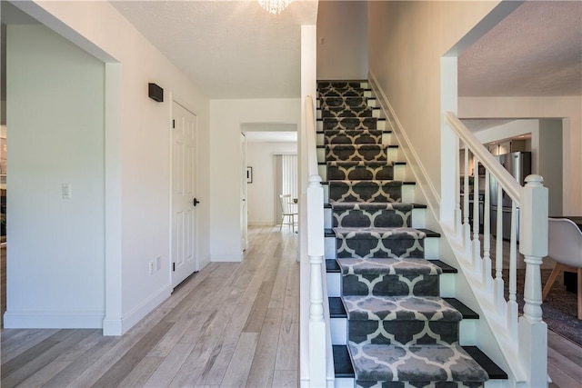 151 Crab Apple Ln, Greece, NY 14626 - stairs featuring wood finished floors and a textured ceiling