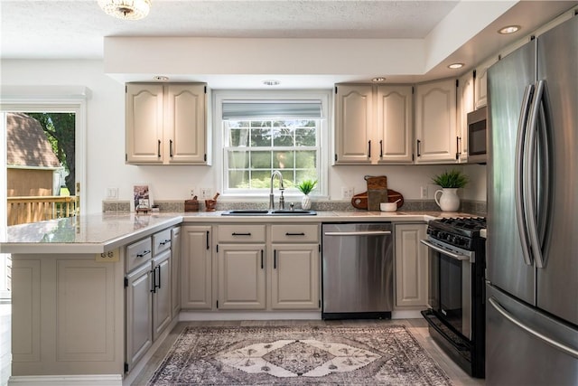 151 Crab Apple Ln, Greece, NY 14626 - kitchen with stainless steel appliances, a peninsula, recessed lighting, light countertops, and a textured ceiling