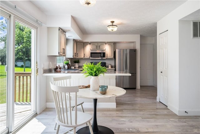 151 Crab Apple Ln, Greece, NY 14626 - dining space featuring baseboards and light wood-type flooring
