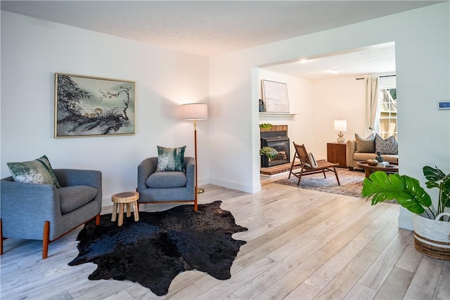 151 Crab Apple Ln, Greece, NY 14626 - sitting room featuring light wood-style flooring and a brick fireplace