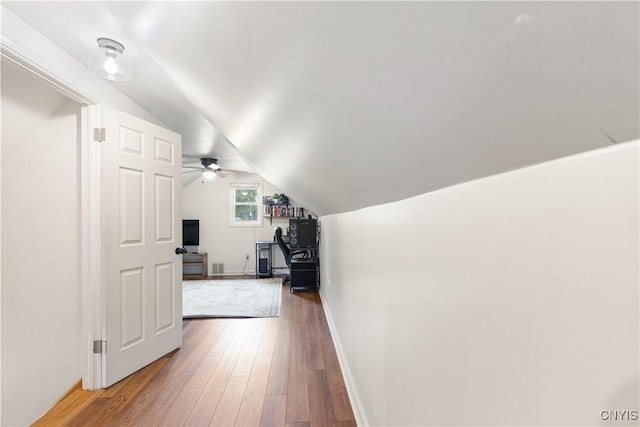 102 Bramley Dr, Camillus, NY 13031 - hallway with wood-type flooring, lofted ceiling, and a desk
