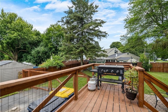 102 Bramley Dr, Camillus, NY 13031 - wooden terrace featuring a fenced backyard, a storage unit, and a grill