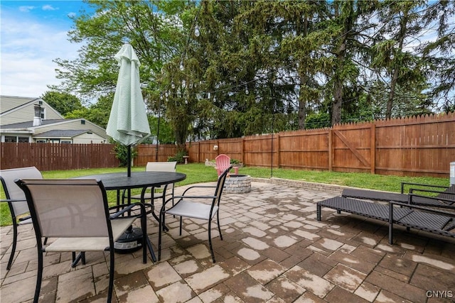 102 Bramley Dr, Camillus, NY 13031 - fenced backyard with a patio area, a fire pit, and outdoor dining space