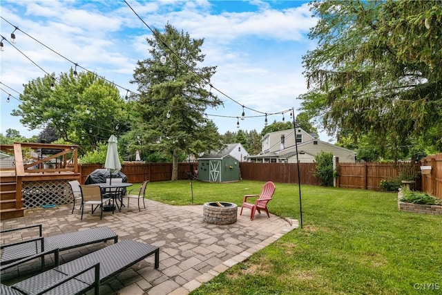 102 Bramley Dr, Camillus, NY 13031 - fenced backyard featuring a fire pit, a shed, a patio area, outdoor dining area, and a deck