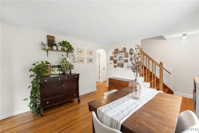 102 Bramley Dr, Camillus, NY 13031 - dining room with arched walkways, stairs, and light wood-type flooring