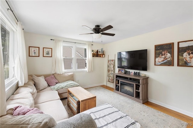 102 Bramley Dr, Camillus, NY 13031 - living area featuring a ceiling fan, wood finished floors, and a glass covered fireplace