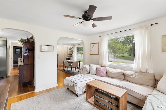 102 Bramley Dr, Camillus, NY 13031 - living area featuring arched walkways, wood finished floors, and a ceiling fan