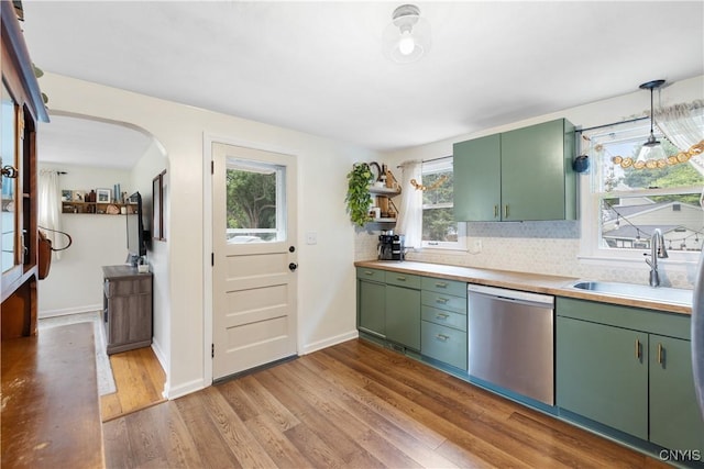 102 Bramley Dr, Camillus, NY 13031 - kitchen with stainless steel dishwasher, green cabinets, light wood-style flooring, and arched walkways