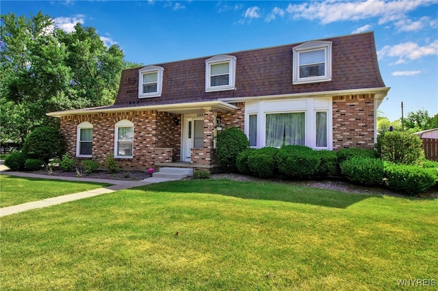204 Belvoir Rd, Amherst, NY 14221 - front facade with a shingled roof, mansard roof, brick siding, and a front yard