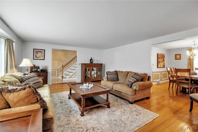 204 Belvoir Rd, Amherst, NY 14221 - living area with stairway, light wood-style flooring, and a chandelier