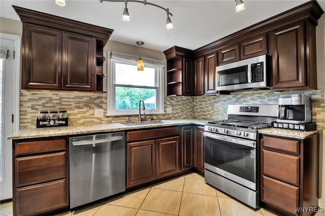 204 Belvoir Rd, Amherst, NY 14221 - kitchen with appliances with stainless steel finishes, light stone counters, light tile patterned floors, and dark brown cabinets