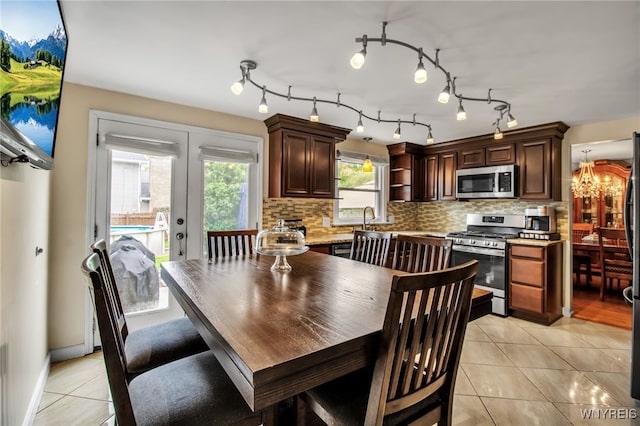 204 Belvoir Rd, Amherst, NY 14221 - dining room featuring light tile patterned floors, a chandelier, and french doors