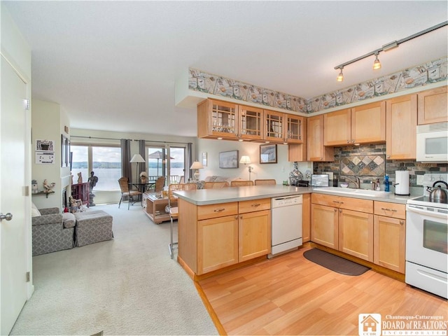38 Oneida Dr, Chautauqua, NY 14728 - kitchen featuring white appliances, open floor plan, a peninsula, light brown cabinetry, and glass insert cabinets