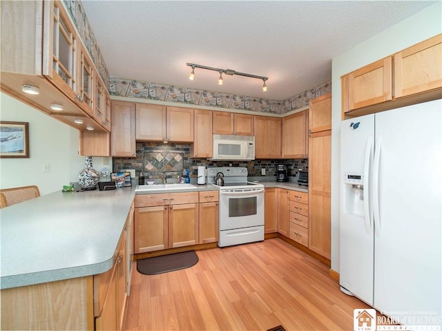 38 Oneida Dr, Chautauqua, NY 14728 - kitchen with white appliances, light brown cabinetry, light wood-style flooring, decorative backsplash, and light countertops