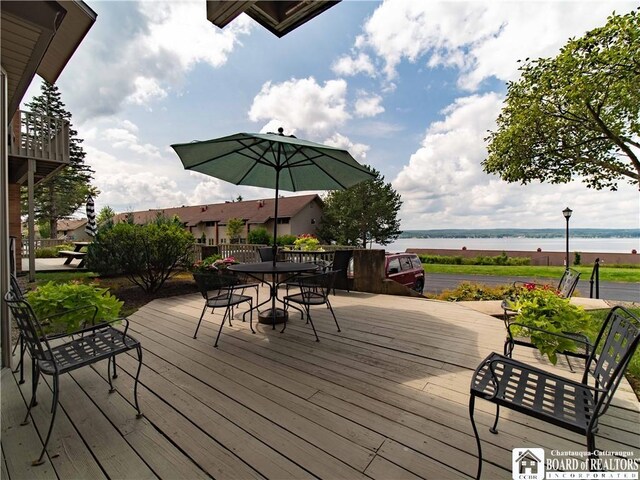 5 Oneida St, Chautauqua, NY 14728 - wooden deck featuring a water view and outdoor dining space