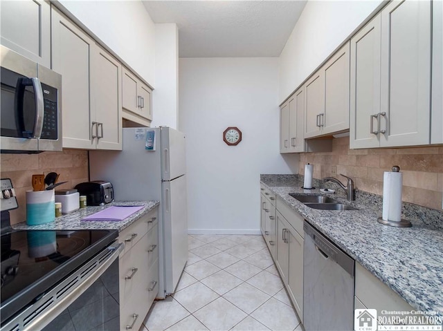 5 Oneida St, Chautauqua, NY 14728 - kitchen featuring appliances with stainless steel finishes, decorative backsplash, light tile patterned floors, and light stone counters