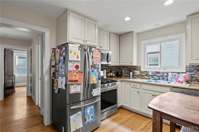 532 Linden Ave, Buffalo, NY 14216 - kitchen featuring stainless steel appliances, tasteful backsplash, light countertops, light wood-type flooring, and recessed lighting