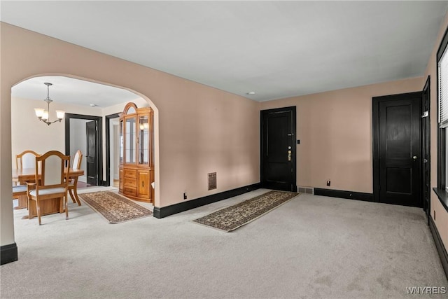 532 Linden Ave, Buffalo, NY 14216 - entrance foyer with arched walkways, carpet floors, and a chandelier