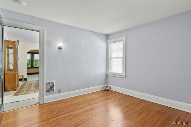 532 Linden Ave, Buffalo, NY 14216 - empty room with arched walkways, light wood-type flooring, and a smoke detector