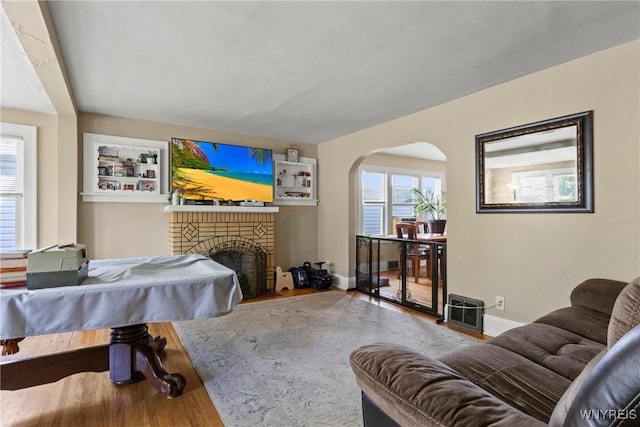 532 Linden Ave, Buffalo, NY 14216 - living room featuring wood finished floors, arched walkways, and a fireplace