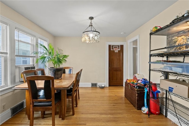 532 Linden Ave, Buffalo, NY 14216 - dining room featuring light wood-style flooring, a chandelier, and cooling unit