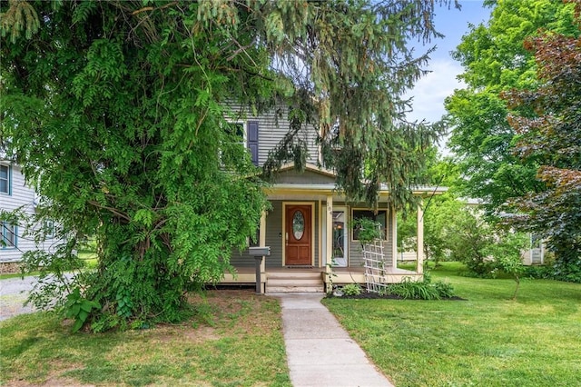 184 Main St, Phelps, NY 14532 - obstructed view of property with a front yard and covered porch