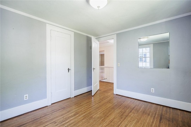 240 Sagamore Dr, Irondequoit, NY 14617 - unfurnished bedroom with wood finished floors, crown molding, and a closet