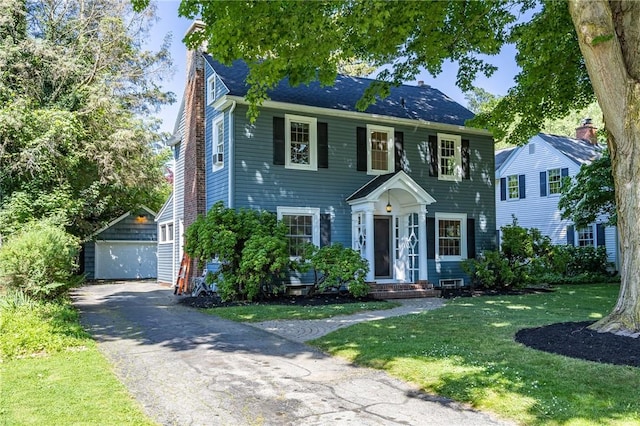 240 Sagamore Dr, Irondequoit, NY 14617 - colonial-style house featuring an outbuilding, a detached garage, a front lawn, and a chimney