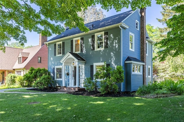 240 Sagamore Dr, Irondequoit, NY 14617 - colonial-style house featuring a chimney and a front yard