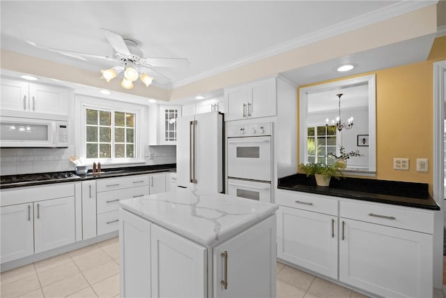 3 Tuxford Rd, Pittsford, NY 14534 - kitchen featuring white appliances, light tile patterned floors, white cabinets, tasteful backsplash, and crown molding