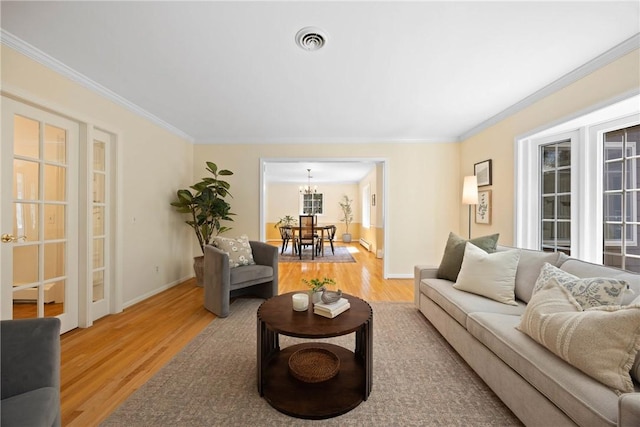 3 Tuxford Rd, Pittsford, NY 14534 - living area featuring light wood finished floors, ornamental molding, a chandelier, and a baseboard heating unit