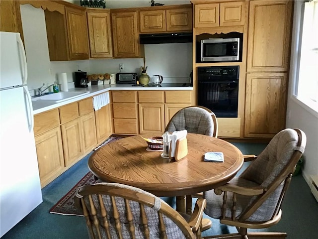 10695 Sandy Hill Rd, Dansville, NY 14437 - kitchen featuring black oven, freestanding refrigerator, stainless steel microwave, light countertops, and under cabinet range hood