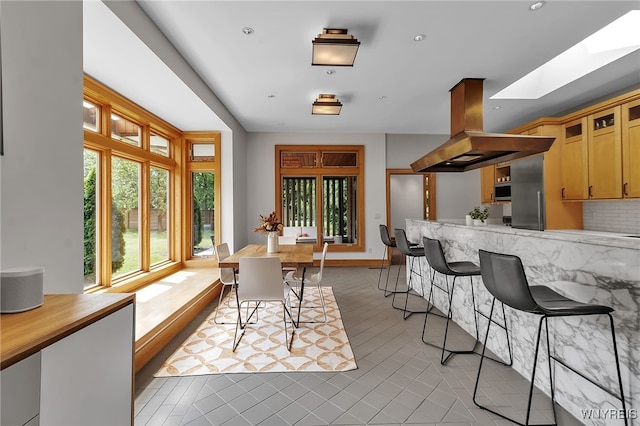 7 Lebrun Cir, Amherst, NY 14226 - dining space with a skylight, recessed lighting, and light tile patterned floors