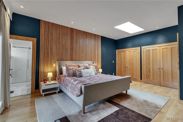 7 Lebrun Cir, Amherst, NY 14226 - bedroom with a skylight, light wood-type flooring, two closets, and ensuite bathroom