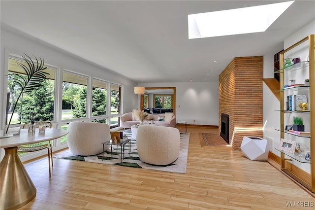 7 Lebrun Cir, Amherst, NY 14226 - living area with a fireplace, light wood-type flooring, a skylight, and recessed lighting