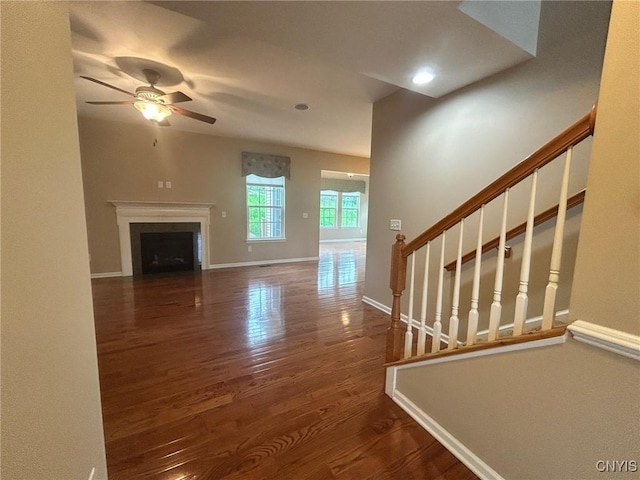 107 Shaker Hts, Camillus, NY 13031 - unfurnished living room with wood finished floors, ceiling fan, stairway, a fireplace, and recessed lighting