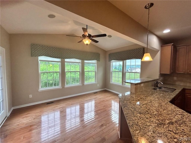 107 Shaker Hts, Camillus, NY 13031 - kitchen featuring light wood-style floors, vaulted ceiling, ceiling fan, hanging light fixtures, and a peninsula